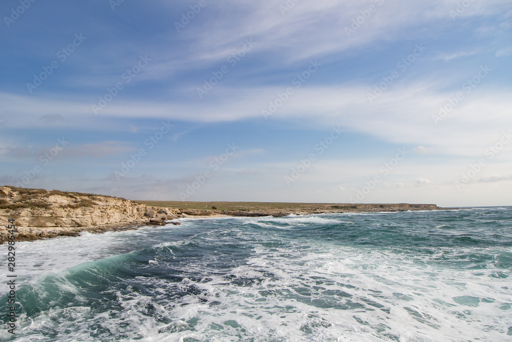 Sea waves crashing against the rocks. Day