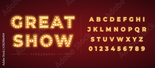 Fotografie, Obraz 3d light bulb alphabet with gold frame isolated on dark red background