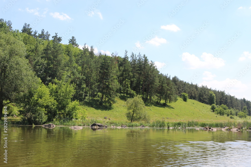 The bank of the plain river invites tired travelers to relax The bank of the plain river invites tired travelers to relax