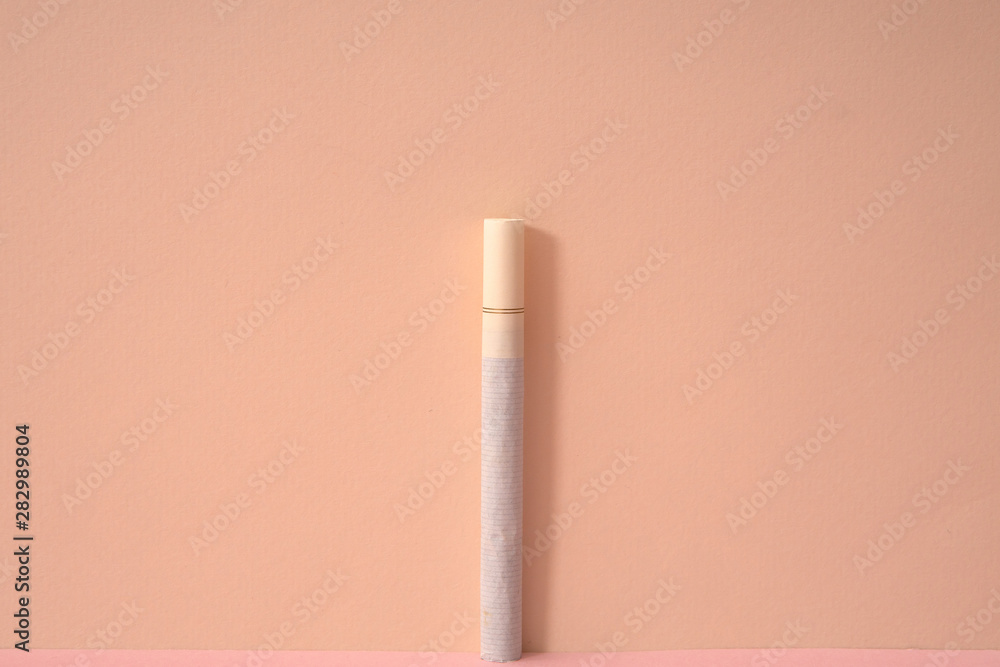 pink color background and a cigarette. pink color background and a cigarette.