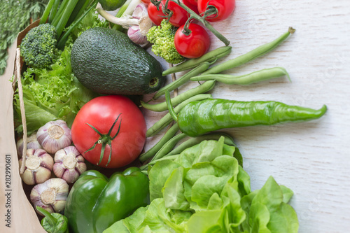 Healthy food in paper bag of different  vegetables on white background. Top view.