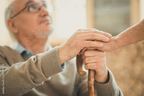 Afraid old man looking on his nurse with hope © zinkevych
