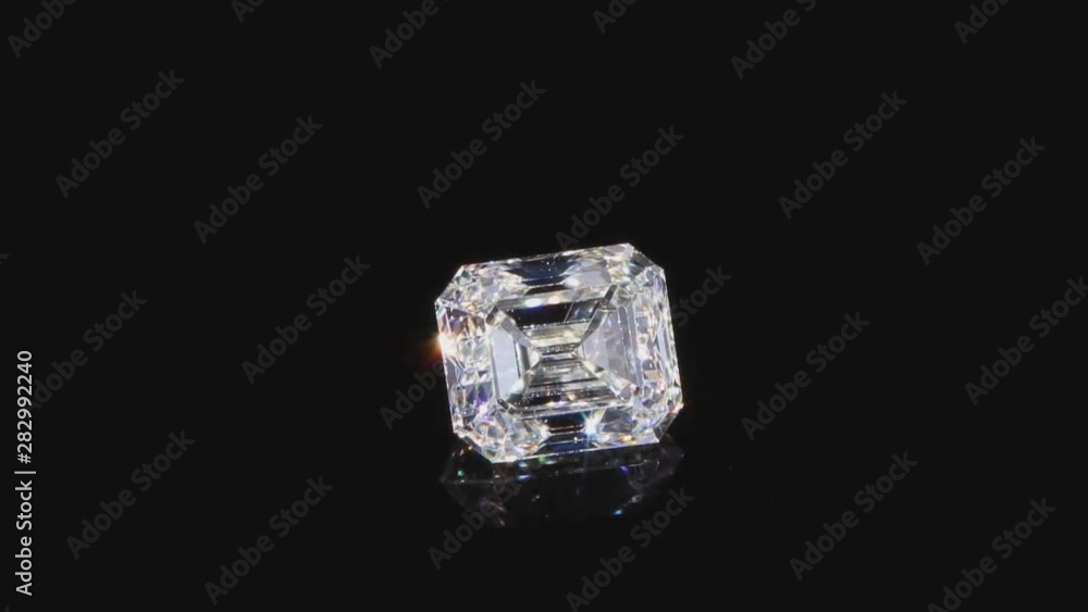 View of a beautiful sparkling 5 carat diamond, close-up on a black background. View of a beautiful sparkling 5 carat diamond, close-up on a black background.