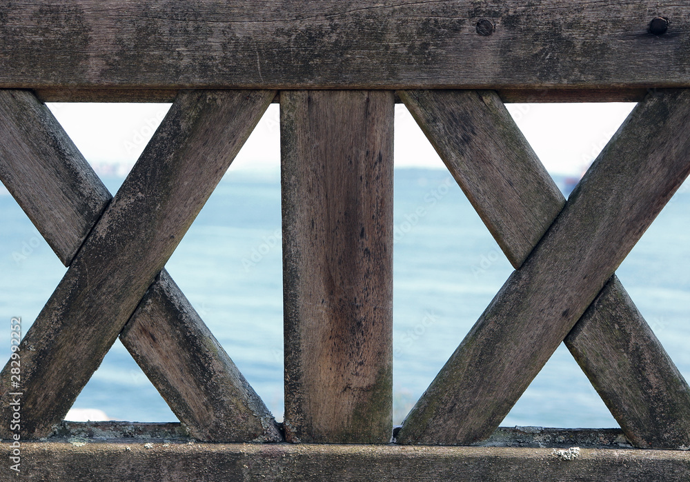 View of ocean through back of a park bench. View of ocean through back of a park bench.