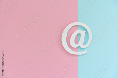 Email symbol on blue and pink background. Concept for email, communication or contact us photo