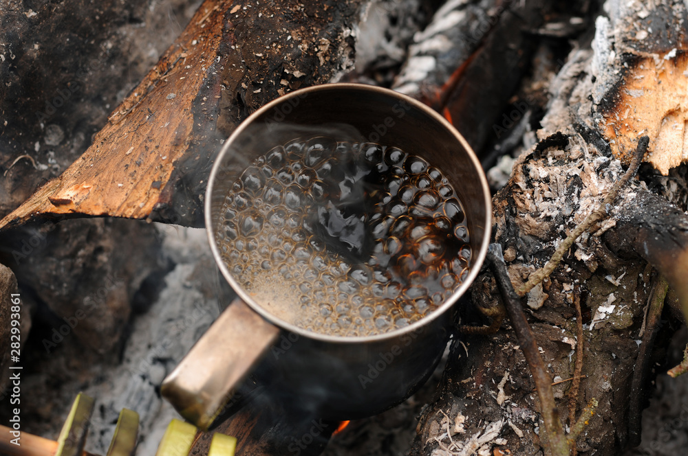 Aromatic and hot coffee on campfire Aromatic and hot coffee on campfire
