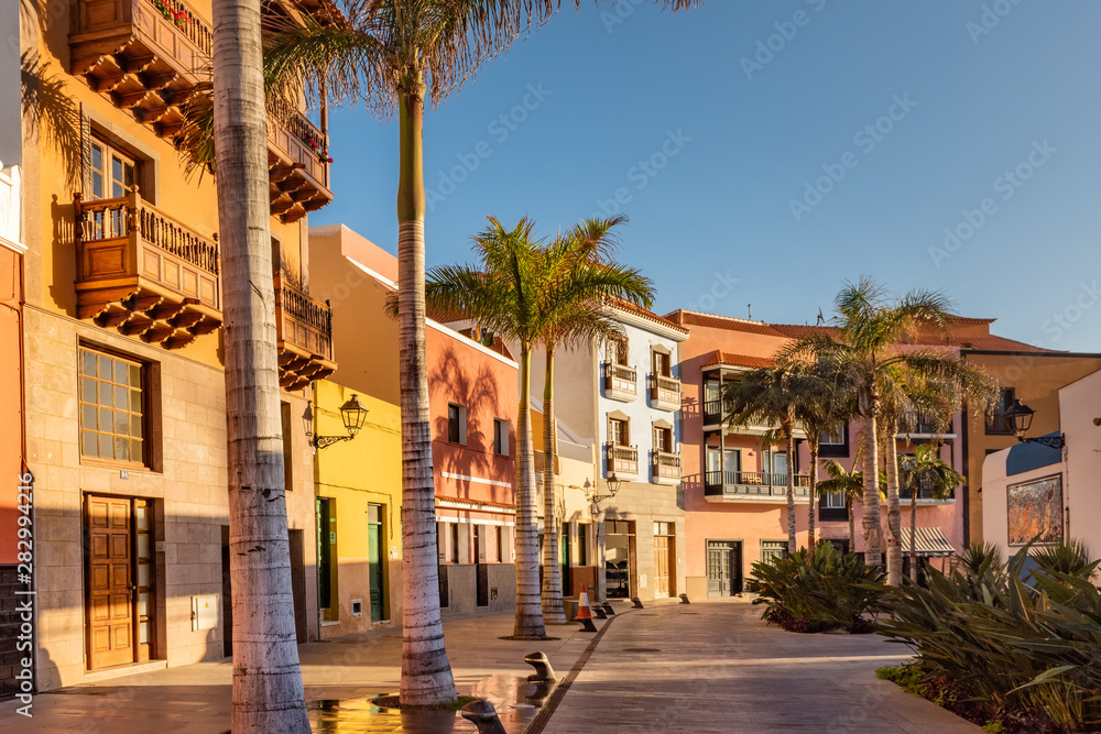 Tenerife. Colourful houses and palm trees on street in Puerto de la Cruz town, Tenerife, Canary Islands, Spain.