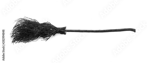 black halloween witch's broom on a white background photo