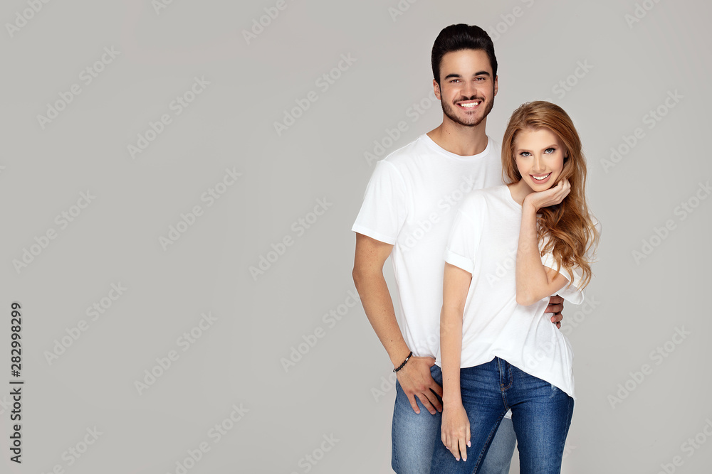 Happy youg couple posing together in studio. Happy youg couple posing together in studio.