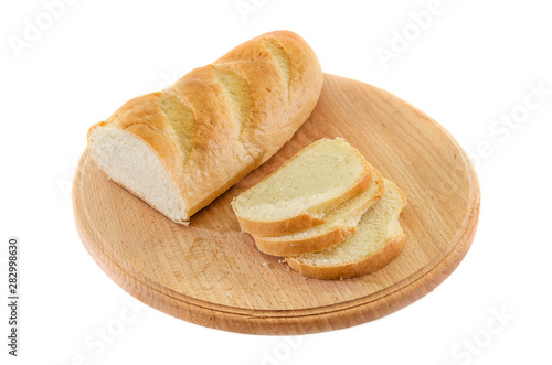 long loaf on a wooden board isolated on white background. Tasty Ukrainian bread