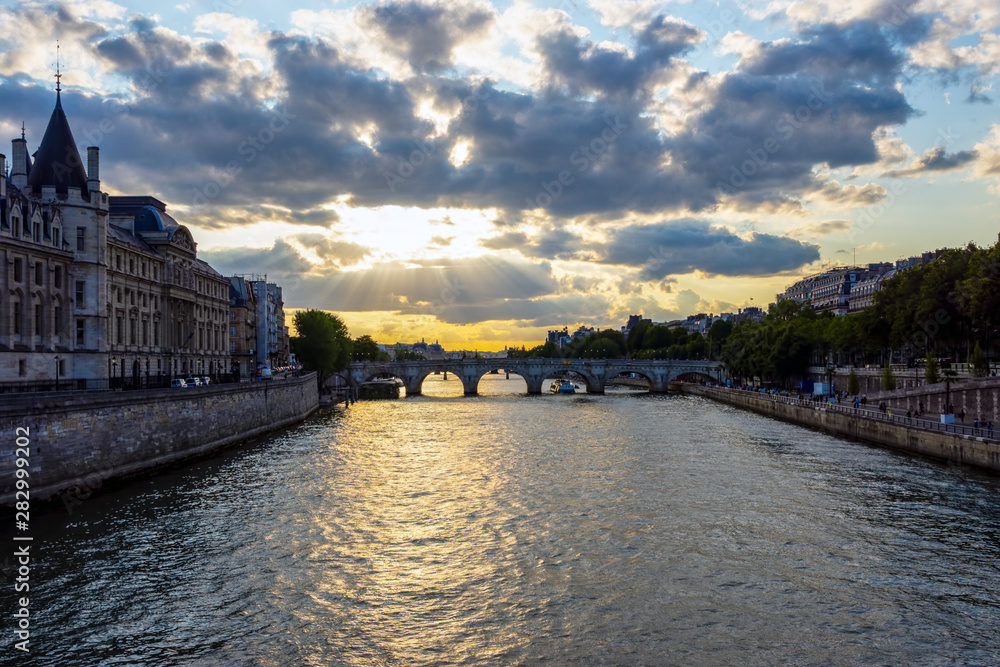 Sunset over Conciergerie and Pont Neuf bridge - Paris, France.