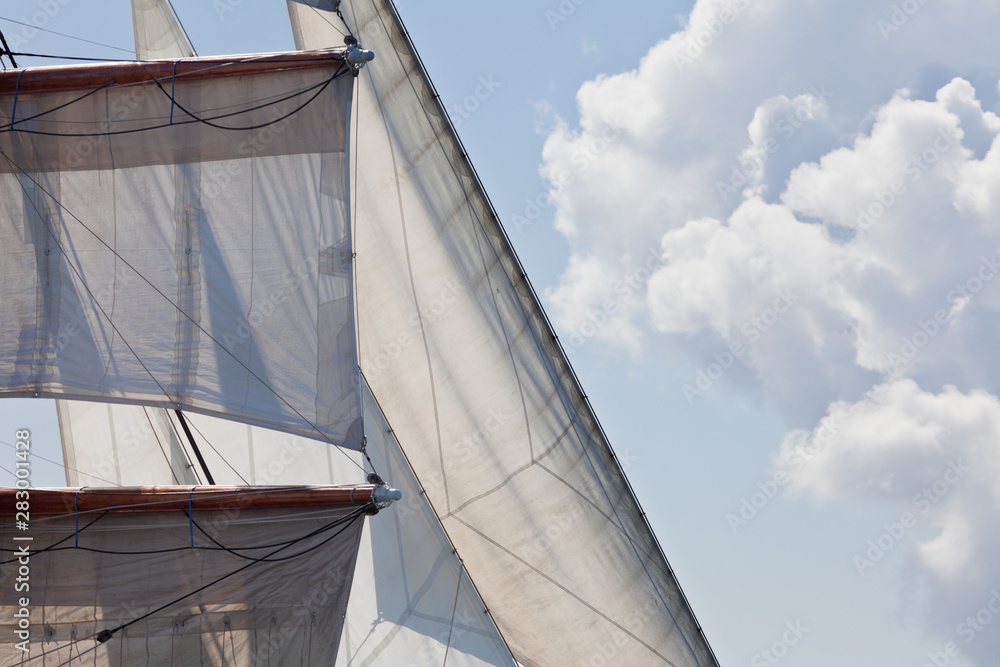 Fototapeta premium Barquentine yacht sails rigging clouds background