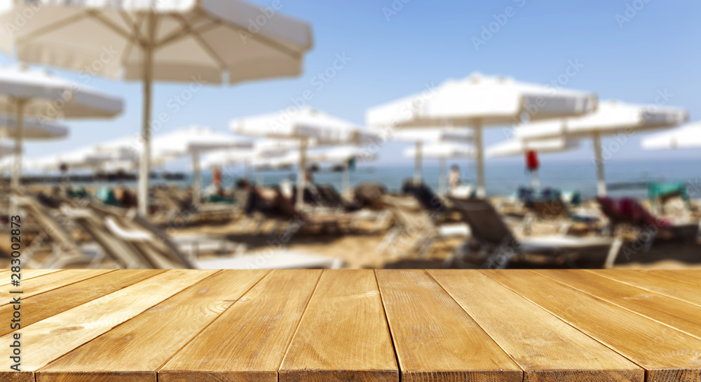 desk of free space and beach background 