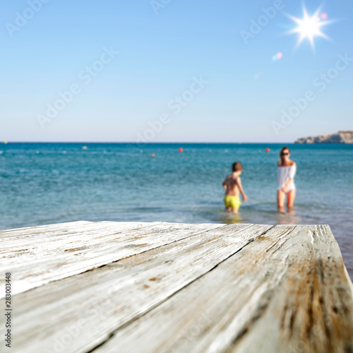 desk of free space and beach background 