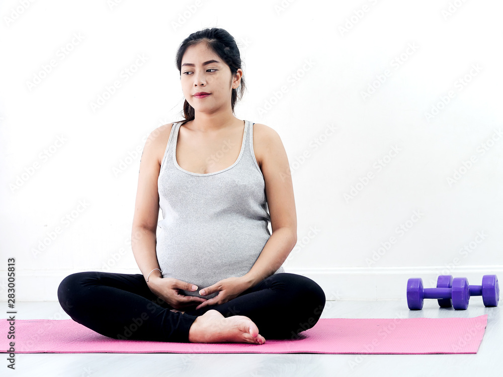Fototapeta premium Asian pregnant woman doing meditating at home, lifestyle concept.