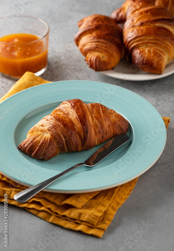 Delicious breakfast with fresh croissants and jam served with butter.