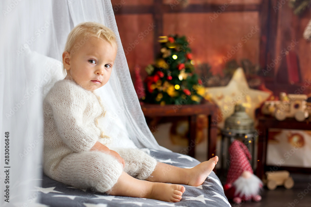 Cute toddler boy, sweet baby, opening presents at Cute toddler boy, sweet baby, opening presents at