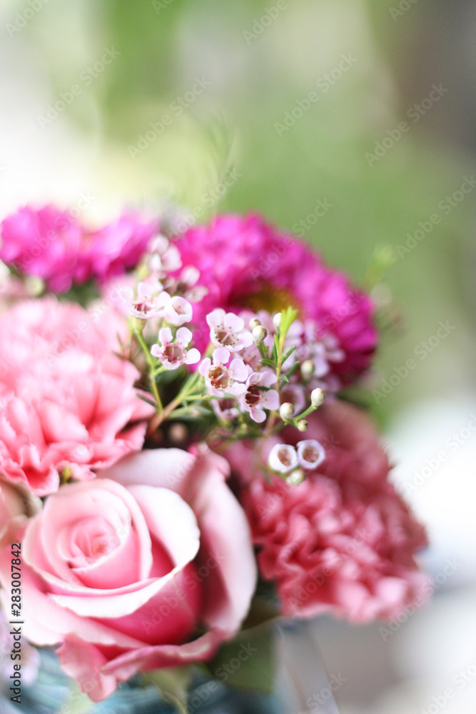 pink roses and flower bouquet in blue mason jar