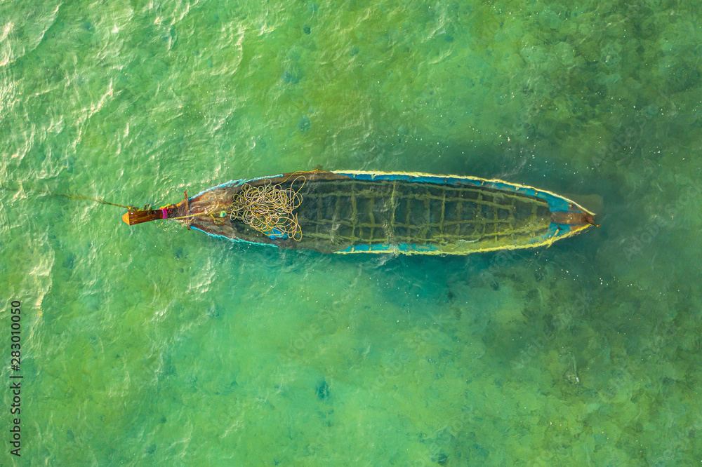 Fototapeta premium a small fishing boat drowned in the sea