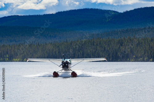 Floatplane landing remote taiga lake in Yukon T