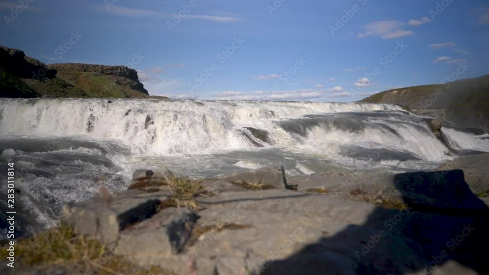 White water, green moss and a clear blue day at the Gullfoss waterfalls, Iceland. Slow motion White water, green moss and a clear blue day at the Gullfoss waterfalls, Iceland. Slow motion