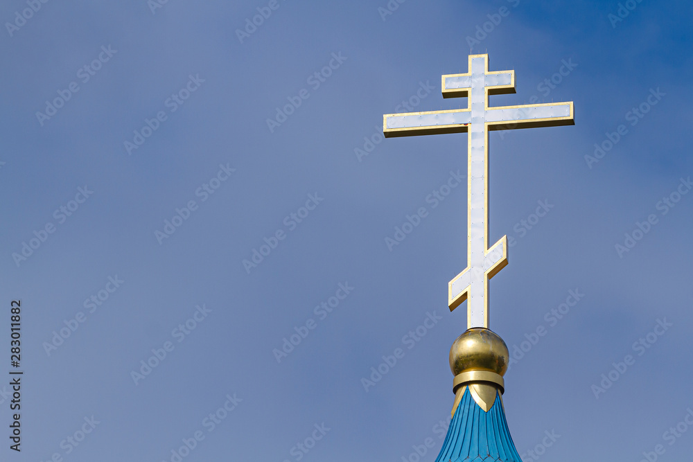The dome of the Orthodox Church with a golden cross against the sky. The dome of the Orthodox Church with a golden cross against the sky.