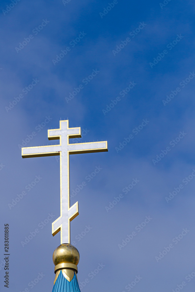 The dome of the Orthodox Church with a golden cross against the sky. The dome of the Orthodox Church with a golden cross against the sky.