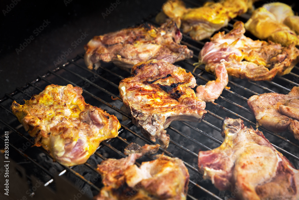 Grilling chicken and pork meat on the grill. Grilling chicken and pork meat on the grill.