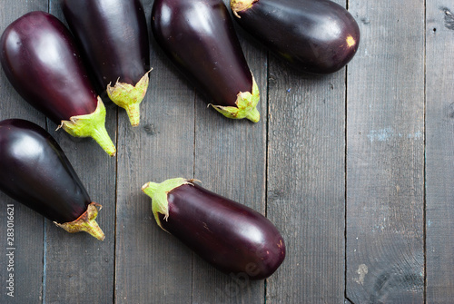 eggplants on black wood table background