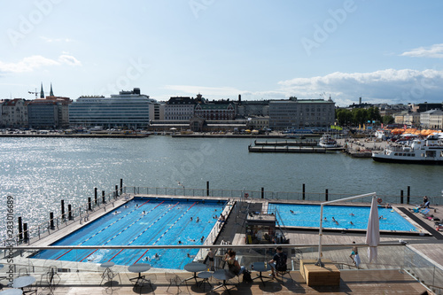  Helsinki, Finland 27.7.2019 Allas Sea Pool, Market Square, Presidental Palace and behind Helsinki Lutherdal Catetral . Suomenlinna ferry has just arrived at the beach. Sunny summer day in the capital photo
