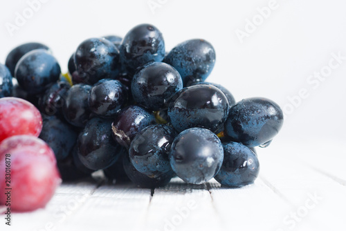 Wallpaper Mural red grapes variation on white wooden Torontodigital.ca