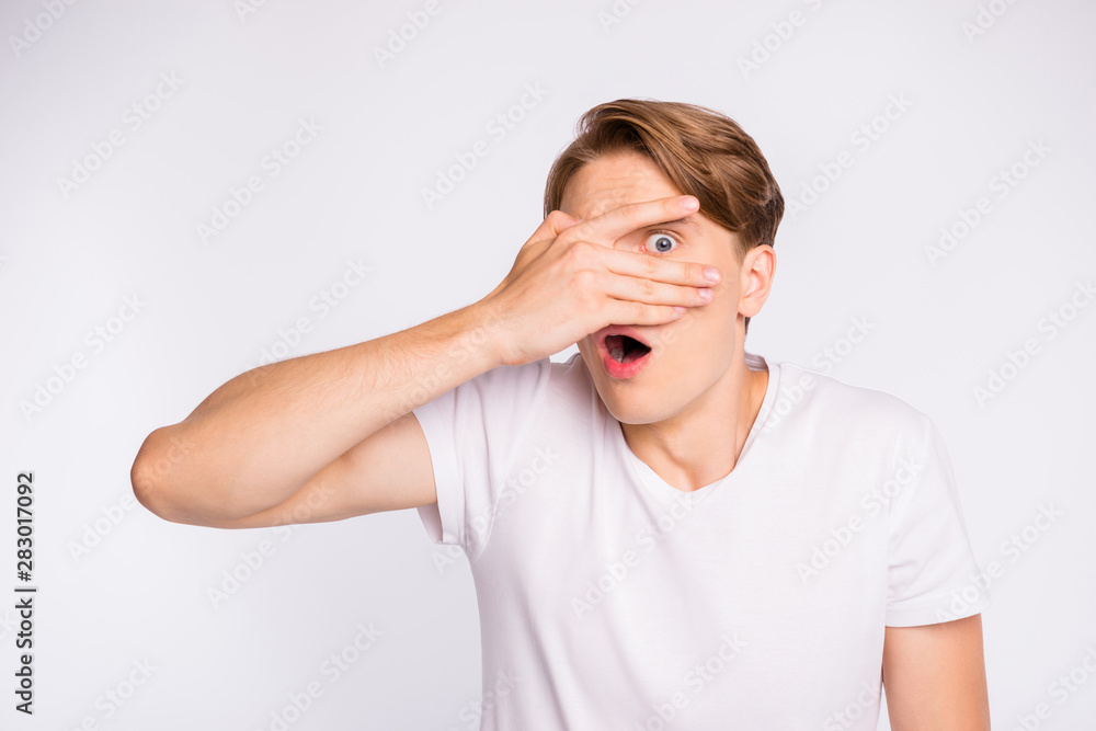 Photo of amazing guy hiding eye with arm watching scary movie wear casual outfit isolated on white background Photo of amazing guy hiding eye with arm watching scary movie wear casual outfit isolated on white background