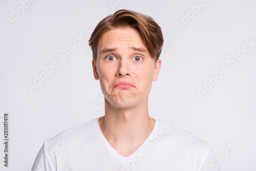 Close-up portrait of his he nice cute attractive desperate guy bad mood news mistake isolated over light white pastel background