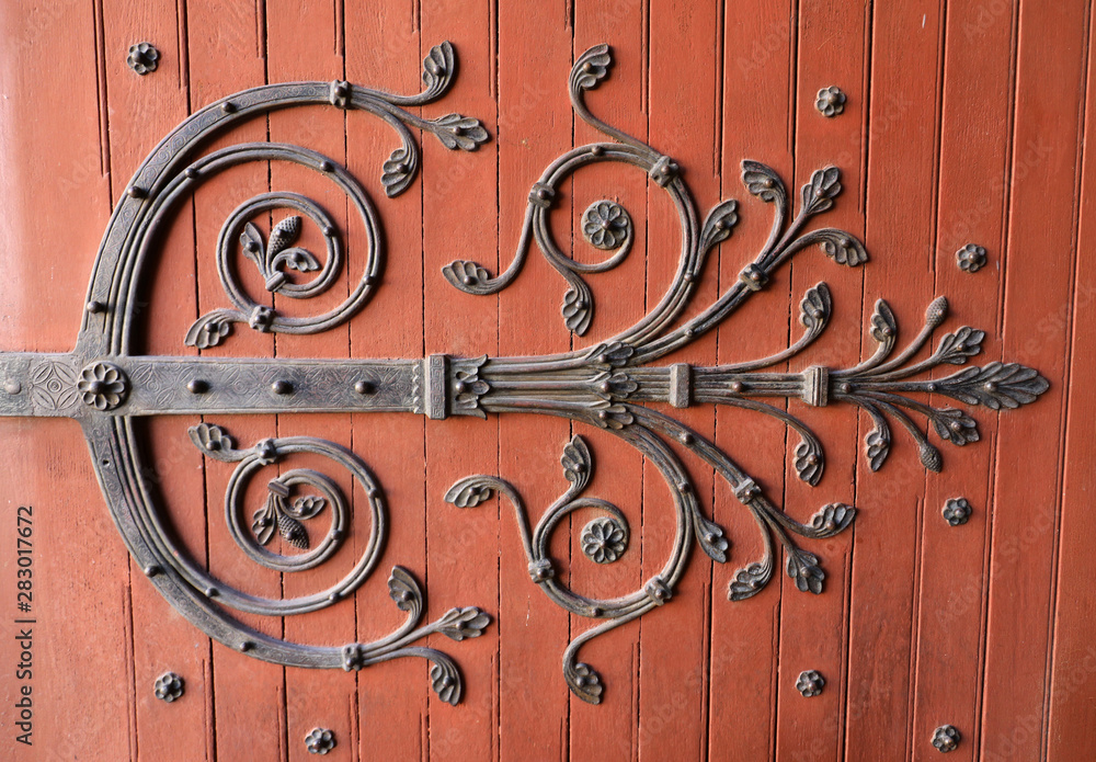 Decorated hinges in the door of Saint Trophime Cathedral in Arles, France. Bouches-du-Rhone, France Decorated hinges in the door of Saint Trophime Cathedral in Arles, France. Bouches-du-Rhone, France