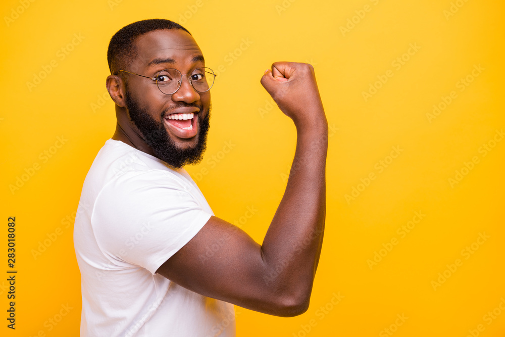 Dark skin guy celebrating lottery winning raising fist up wear casual outfit isolated yellow background Dark skin guy celebrating lottery winning raising fist up wear casual outfit isolated yellow background