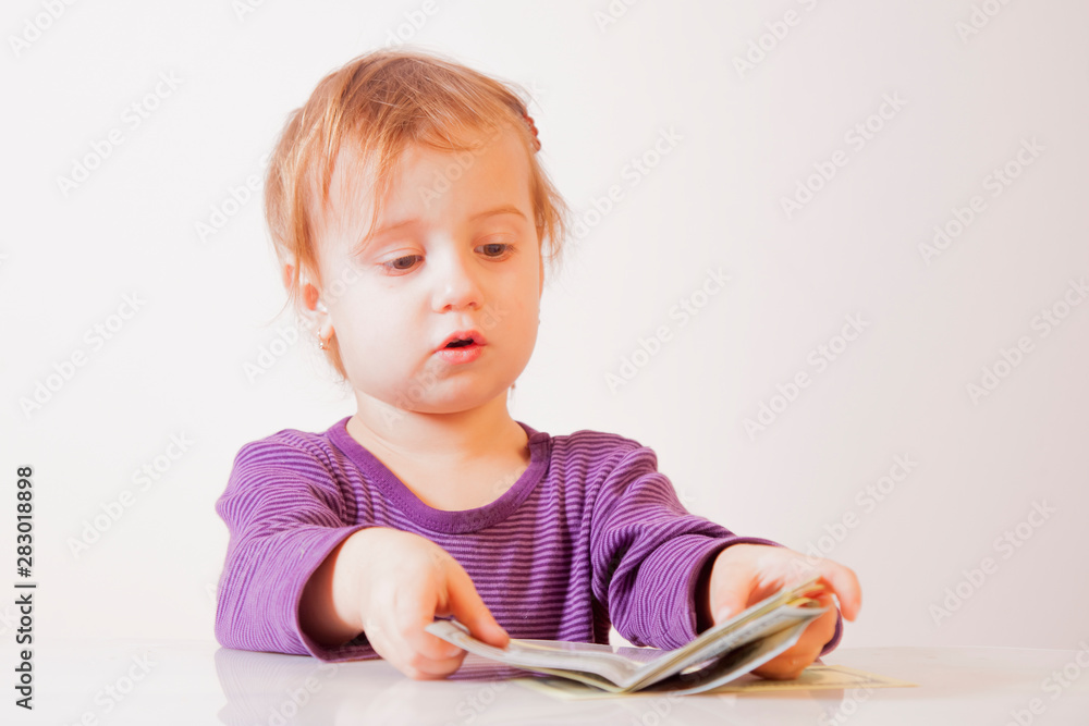 Teaching kids about money and business. Little cute child girl with US Dollars banknotes. Teaching kids about money and business. Little cute child girl with US Dollars banknotes.