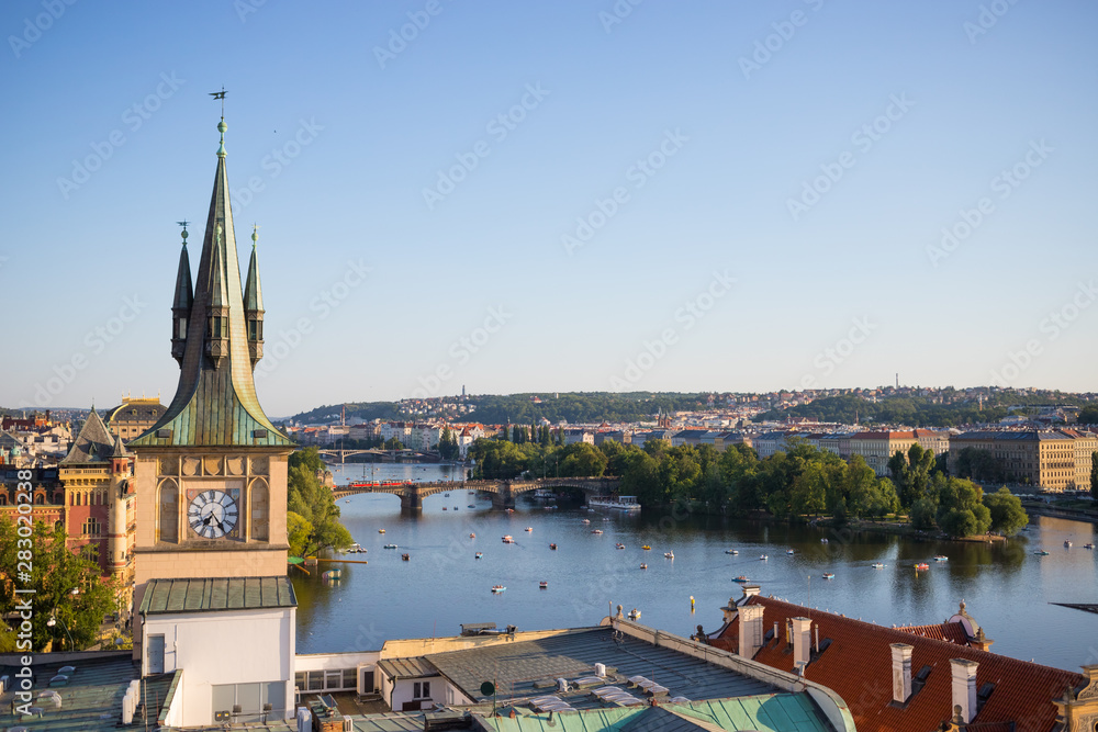 Fototapeta premium Old town water tower with Legions Bridge on Vltava river in background, Prague.