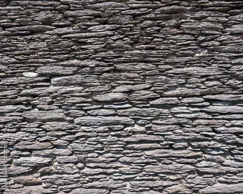 very old wall made of flat natural stones in ireland
