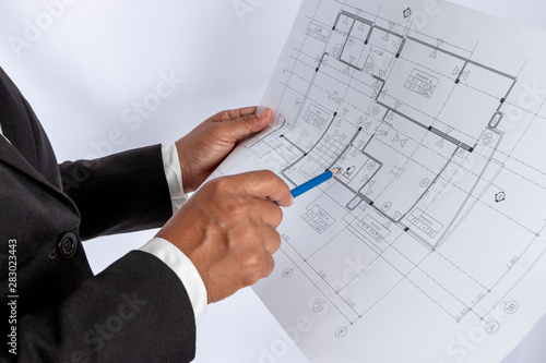 Businessman in the hand have a construction plan or architectural plan, Used for related professional house trading, real estate, construction.