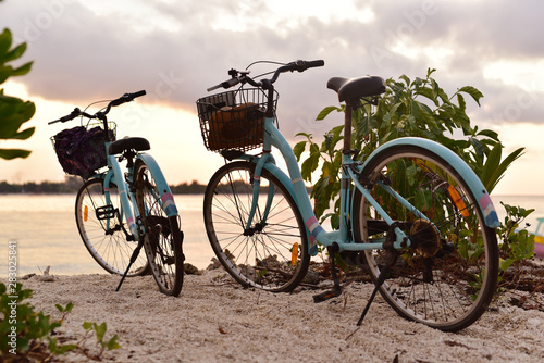 Two bicycles parked on the beach of Gili Meno Island in sunset, Lombok, Indonesia © akturer