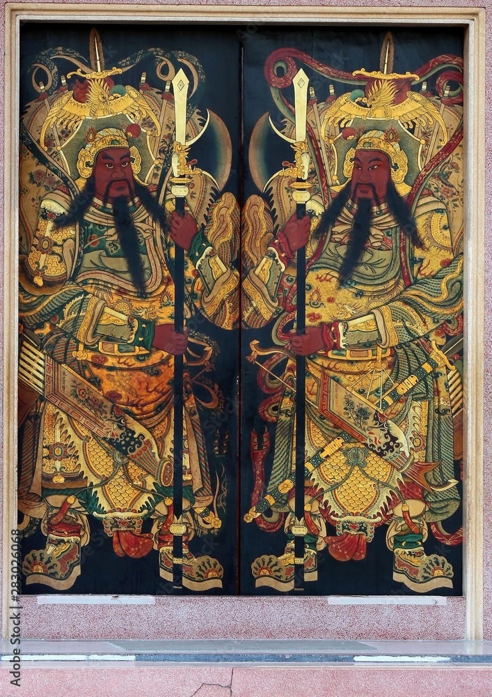 Guardians painted on double doors at the entrance to an ancient Chinese temple