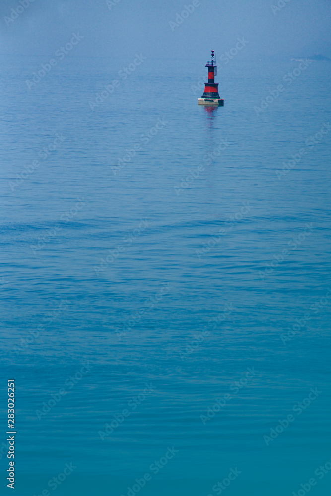 black and red buoy on the sea