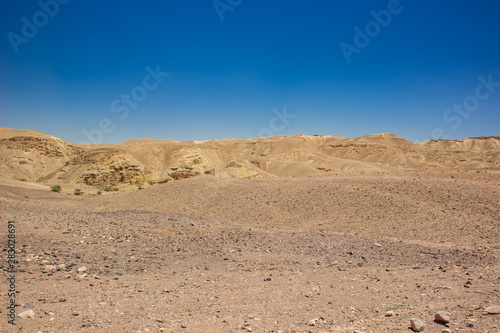 desert valley wasteland scenic landscape view of nothing with sand stone bare mountain ridge background