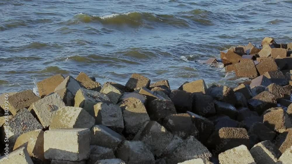 Sea Waves Sway On The Rocky Shore On A Cloudy Summer Day Sea Waves Sway On The Rocky Shore On A Cloudy Summer Day