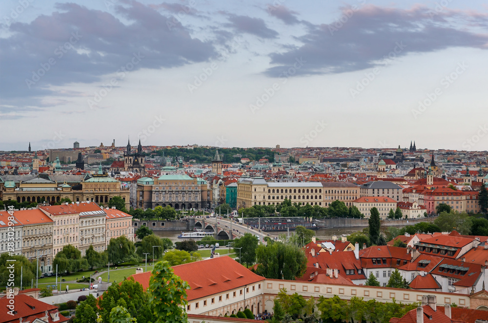 Scenic panoramic view of bridges on the Vltava river and historical center of Prague, Czech Republic on sunset