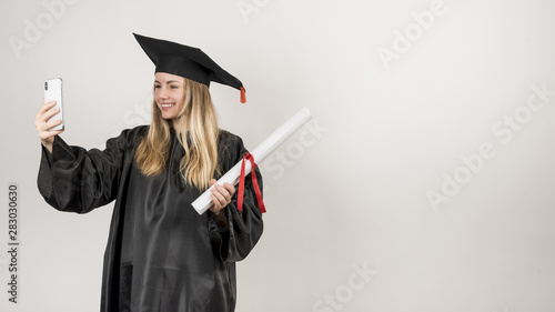 Graduate taking a selfie with her phone