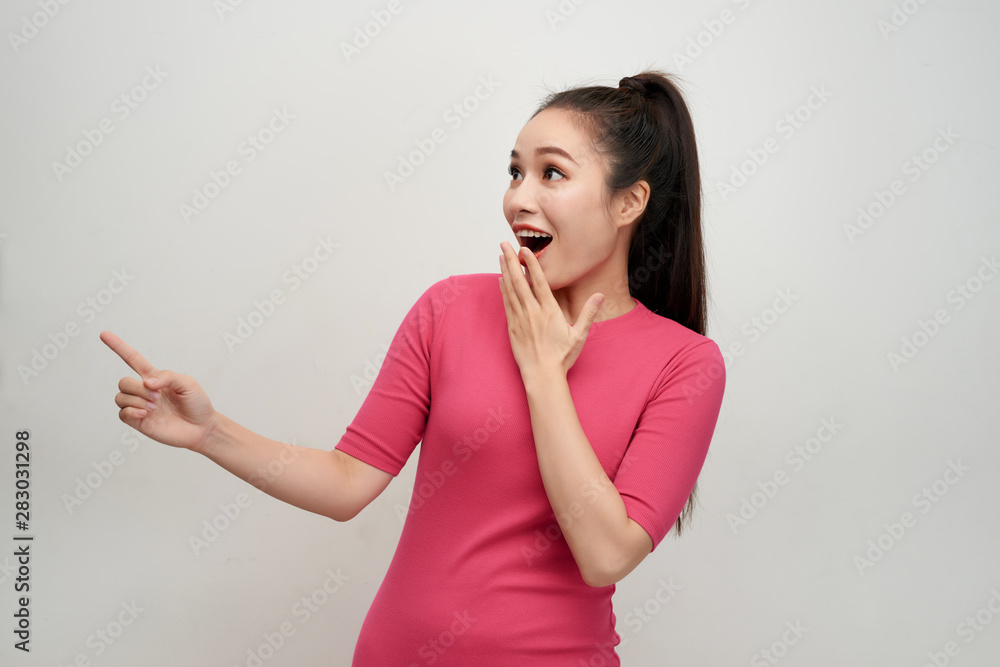 Happy surprised young female smiling broadly at camera, pointing fingers away Happy surprised young female smiling broadly at camera, pointing fingers away