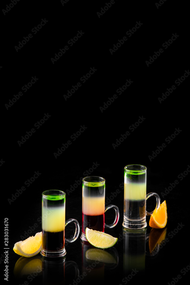 three different alcoholic cocktails on a black background isolated three different alcoholic cocktails on a black background isolated