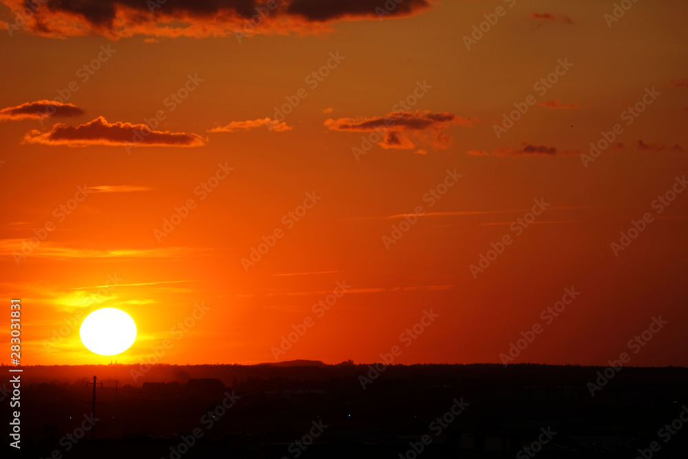 Red color sunset with several clouds in the sky