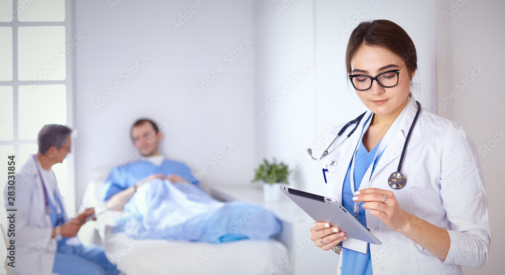 Doctor checking heart beat of patient in bed with stethoscope Doctor checking heart beat of patient in bed with stethoscope